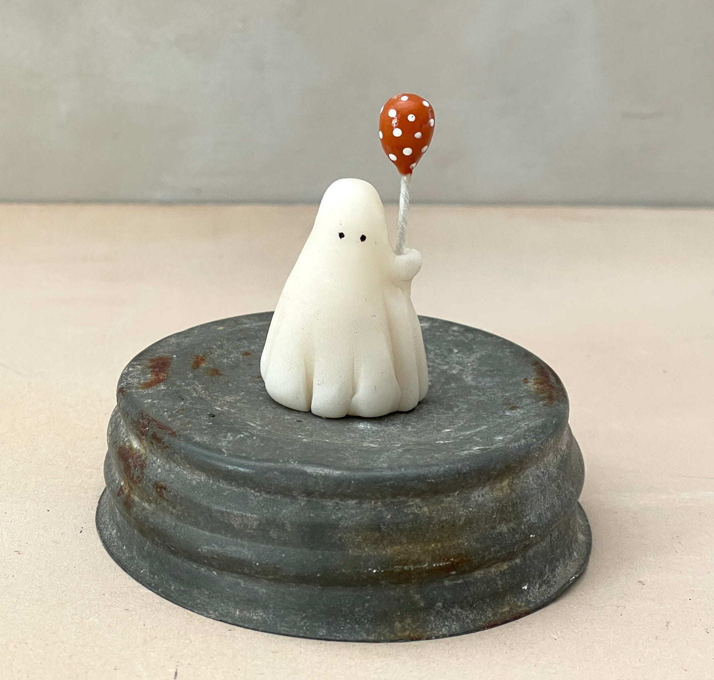 Miniature ghost with orange polka dot balloon