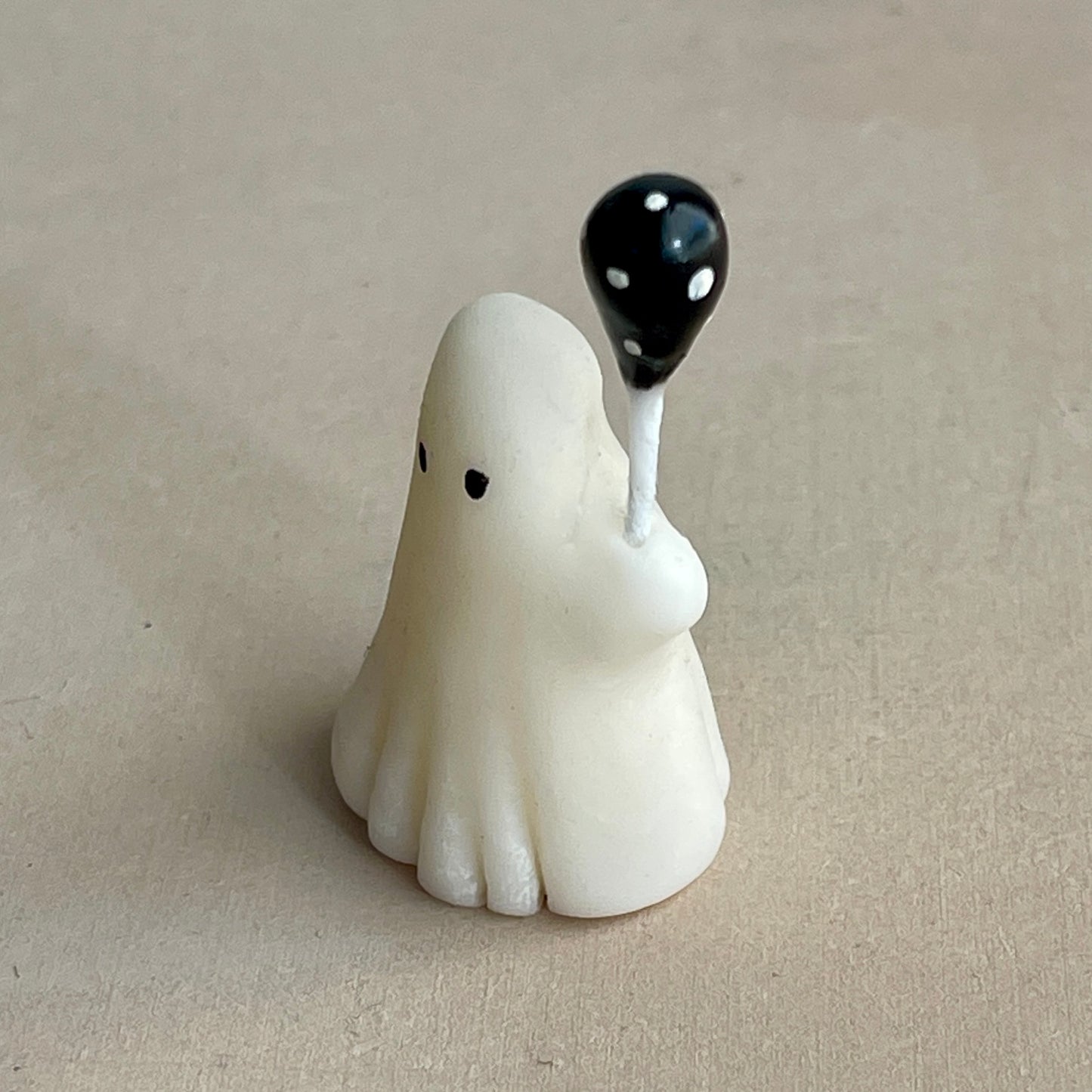 Miniature ghost with black polka dot balloon