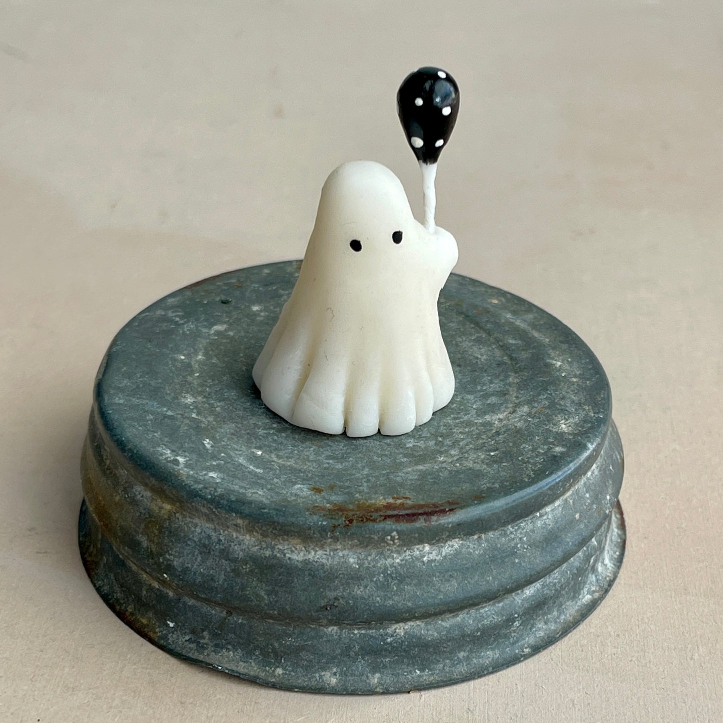Miniature ghost with black polka dot balloon