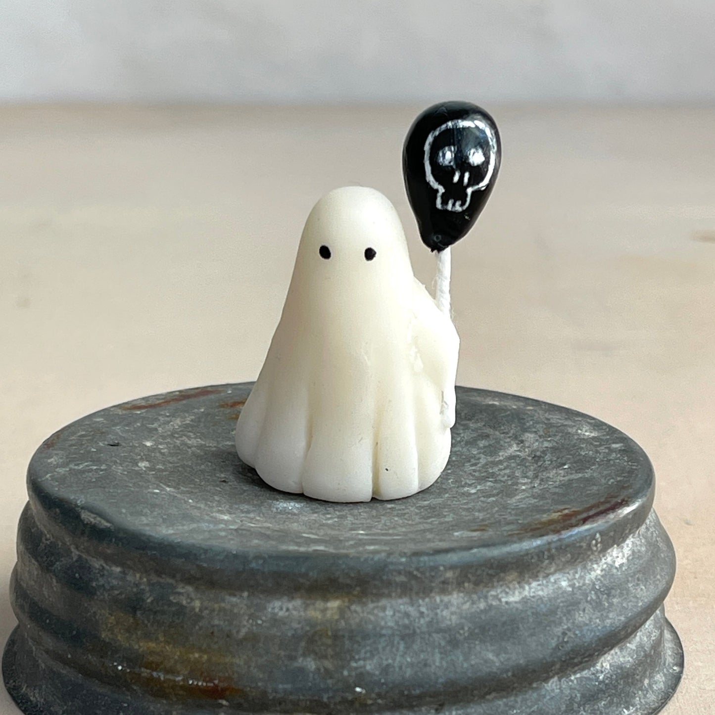 Miniature ghost with skull balloon