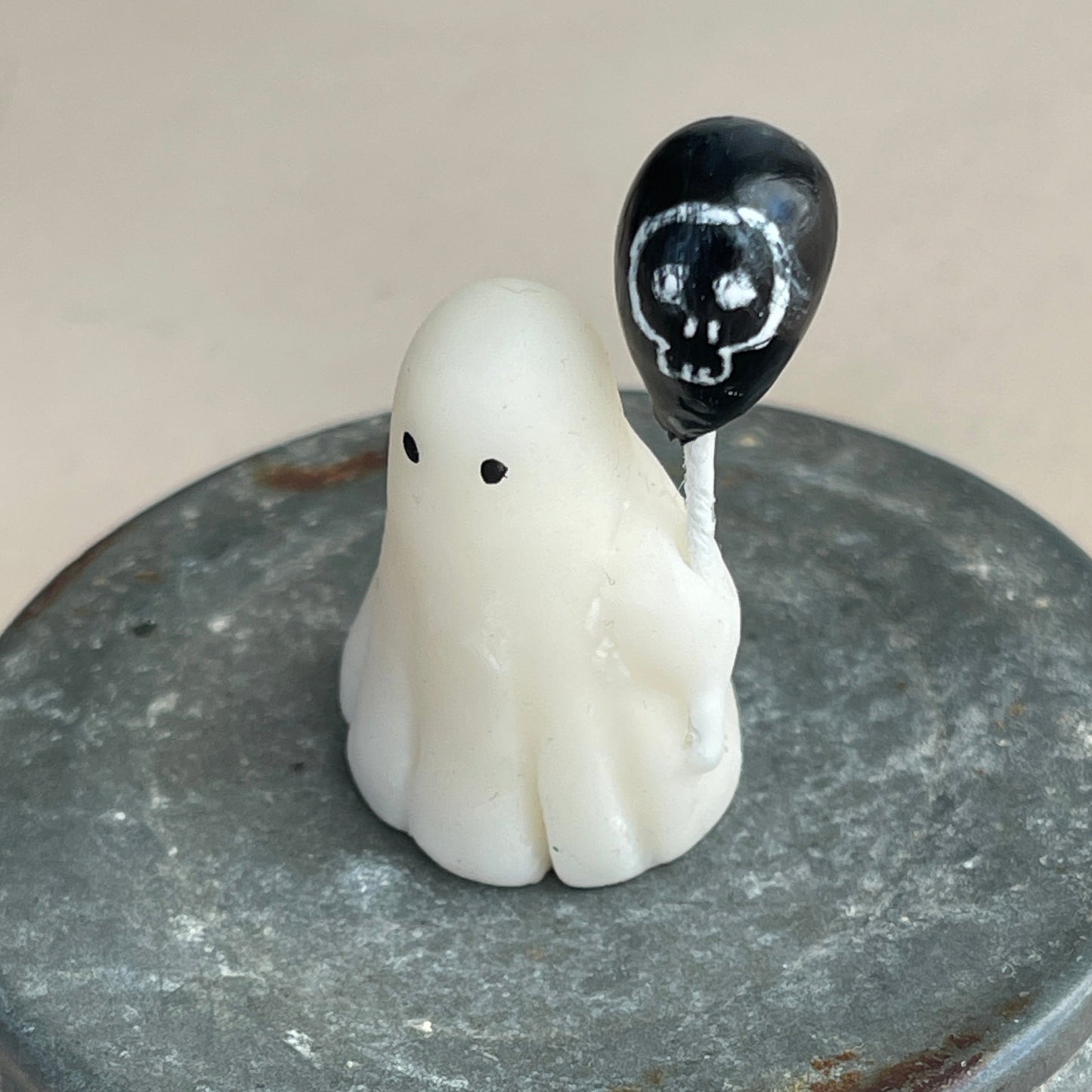 Miniature ghost with skull balloon