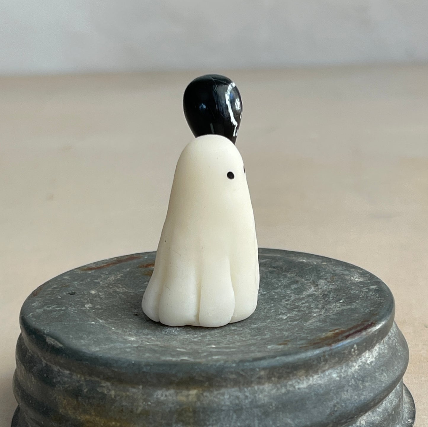 Miniature ghost with skull balloon