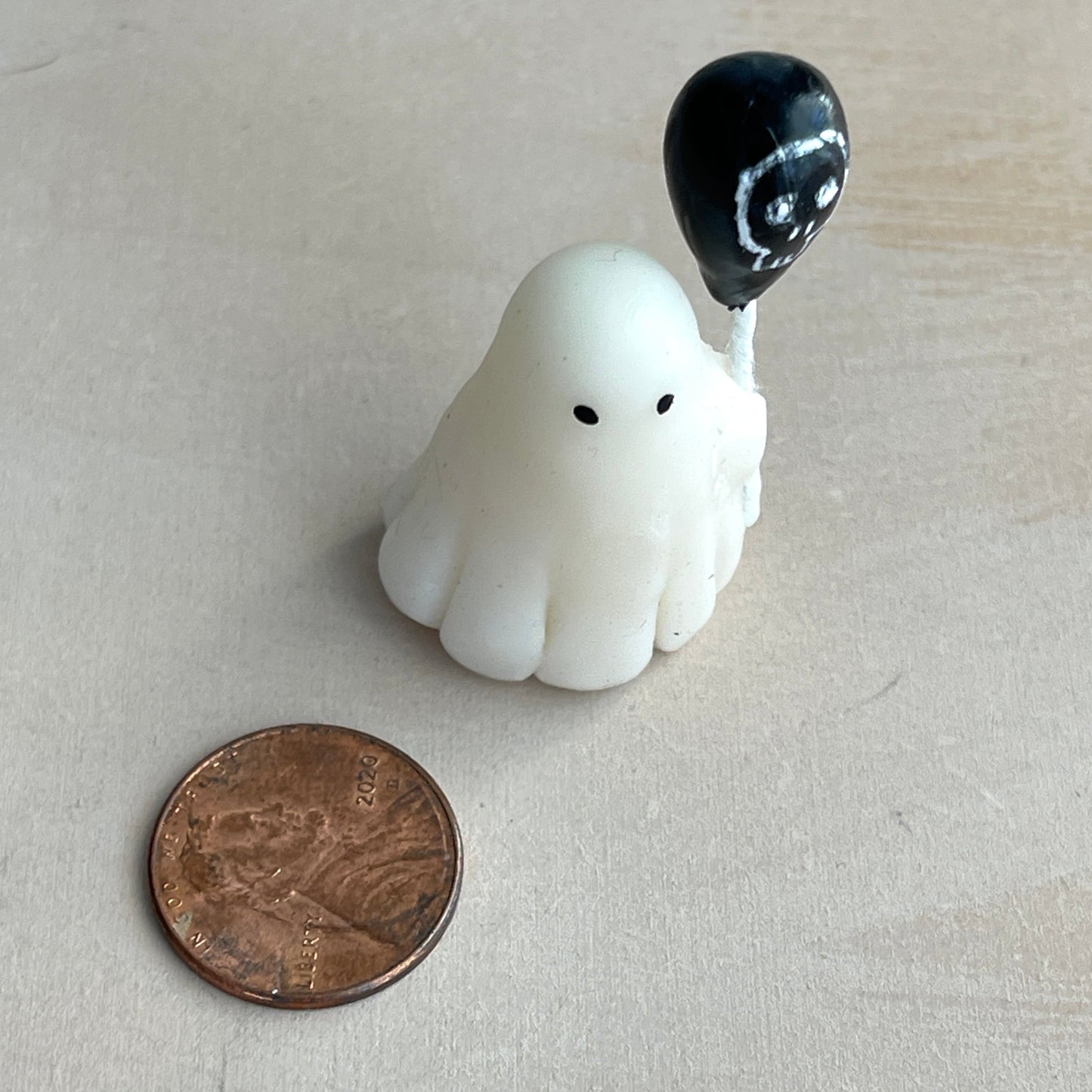 Miniature ghost with skull balloon